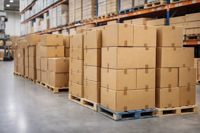 Corrugated cartons stacked on pallets at a packaging and corrugation unit